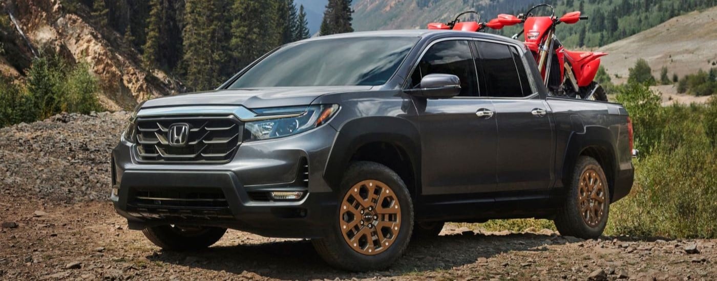 A grey 2020 Honda Ridgeline HPD angled left and parked off-road.