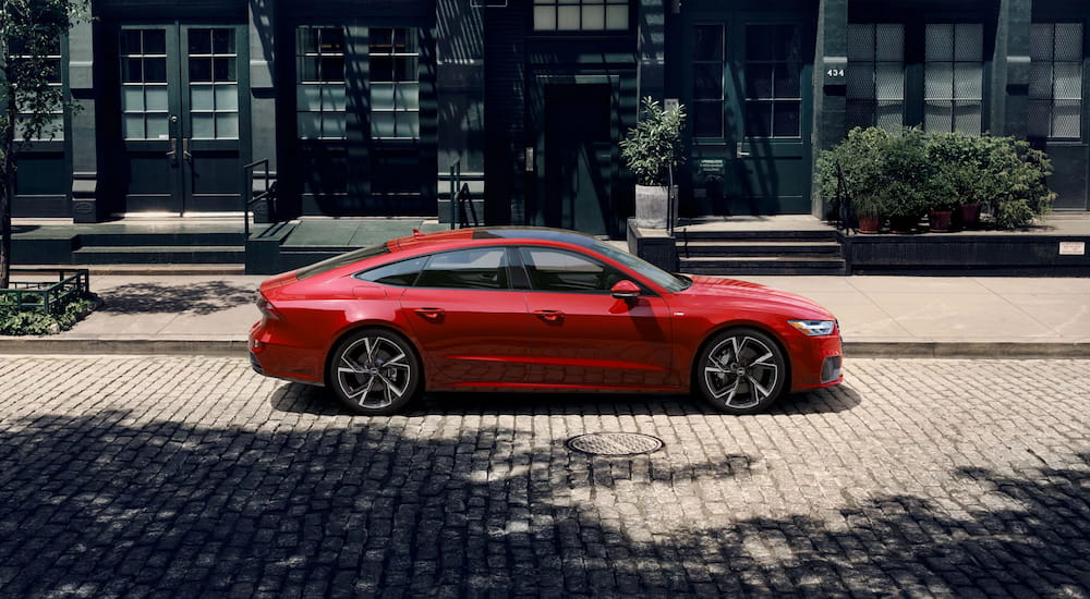 Car Dealership Near Cary - 2025 Audi A7 - Red copy.jpg Side of a red 2025 Audi A7 parked by a curb.