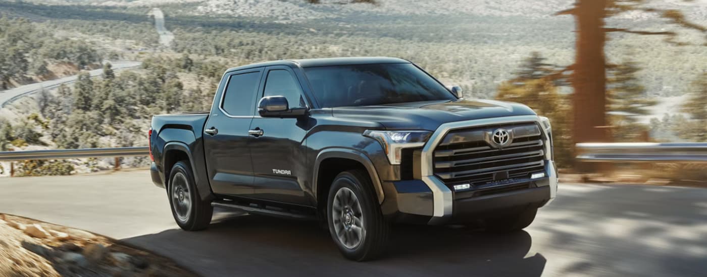 Black 2026 Toyota Tundra driving up a hill