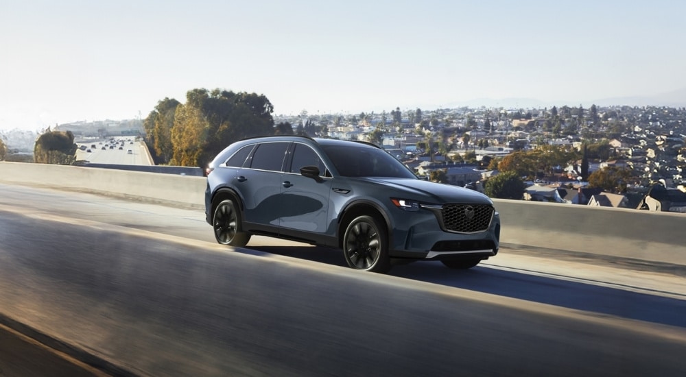 Grey 2026 Mazda CX-90 driving on a highwat