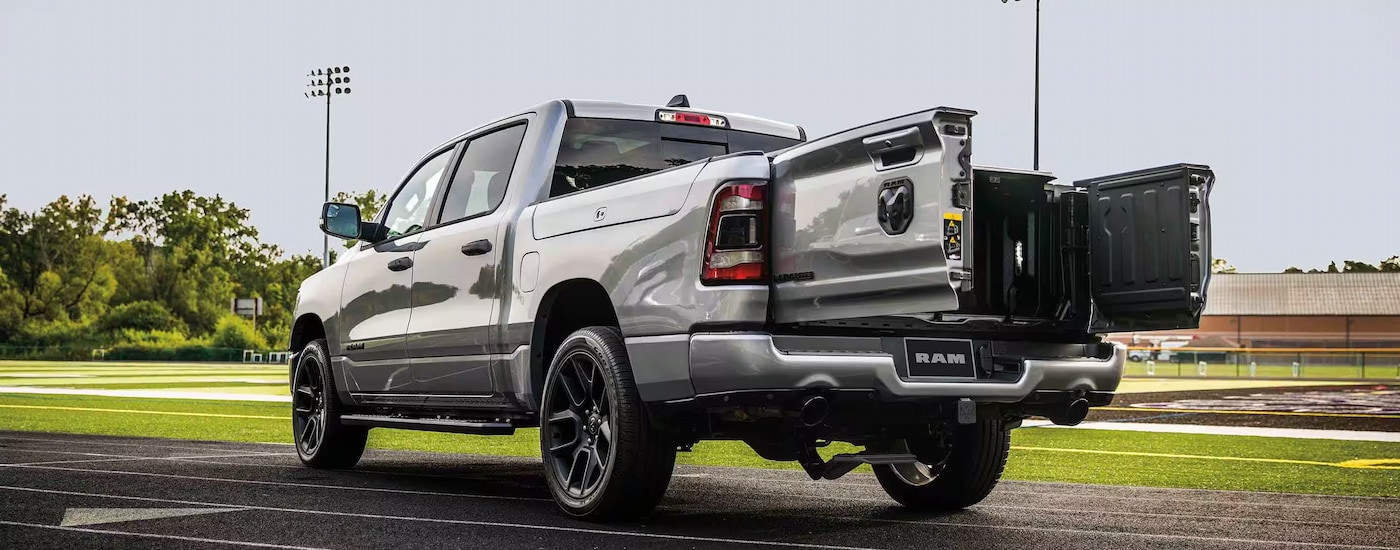 Rear view of a silver 2023 Ram 1500 Laramie with the Multifunction Tailgate open.
