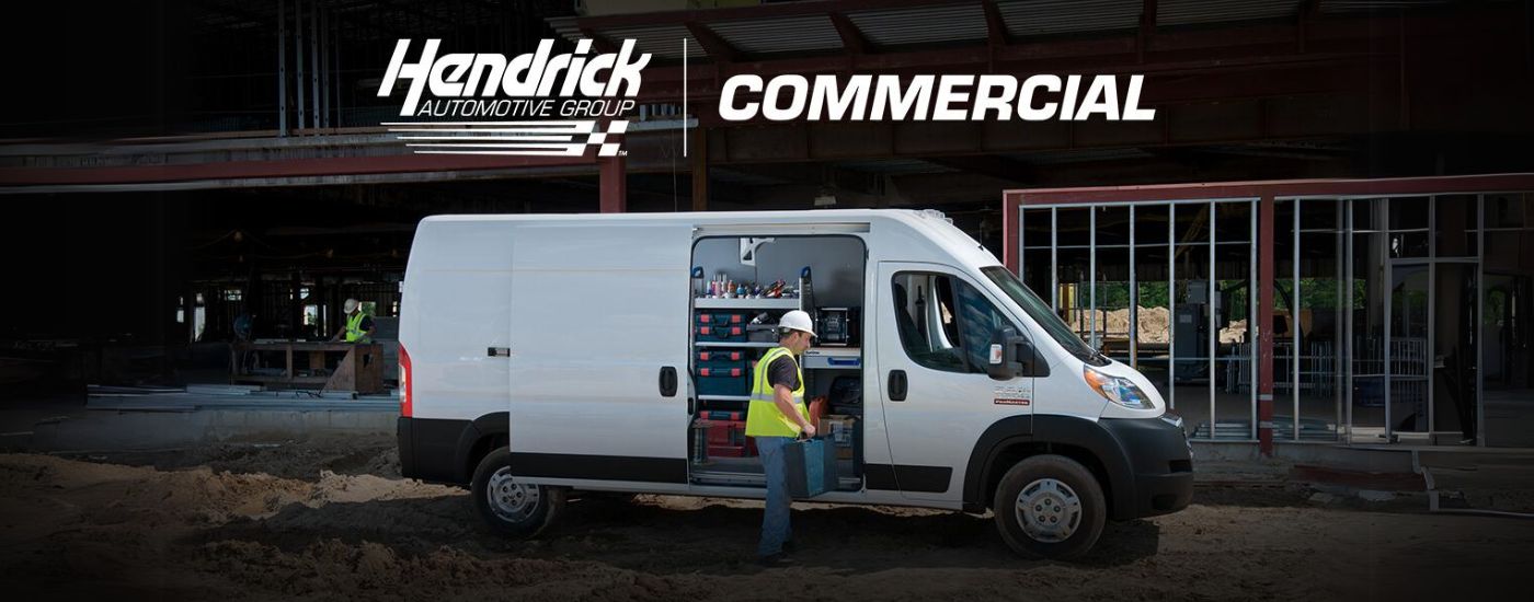 A worker is shown getting tools from a white commercial van.