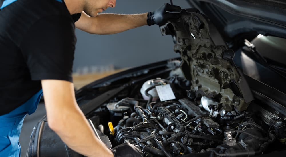 A mechanic is inspecting a vehicle's engine.