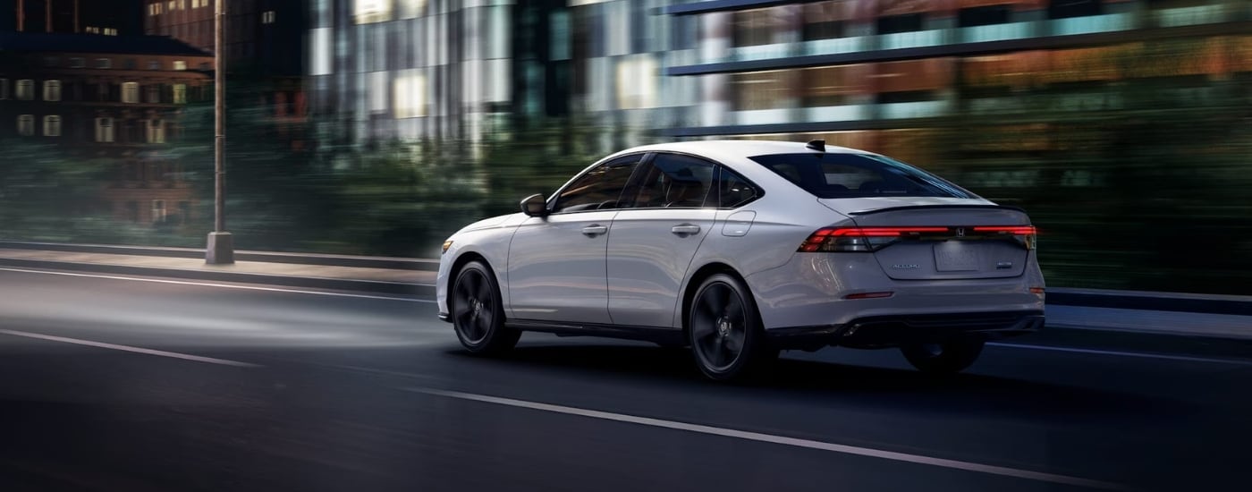 A white 2025 Honda Accord from the rear at an angle after leaving a car dealer near Fayetteville.