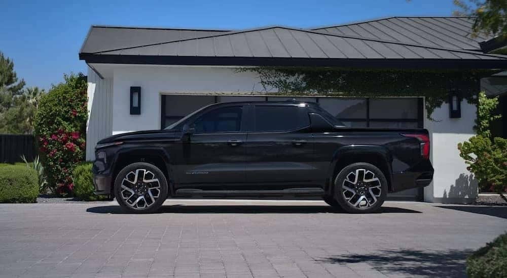 A black 2026 Chevy Silverado EV parked in a driveway