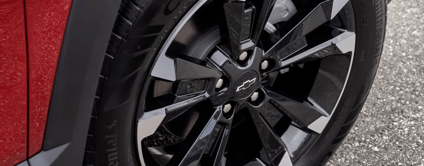 Black rim and tire on a red 2025 Chevy Equinox car for sale near Goose Creek