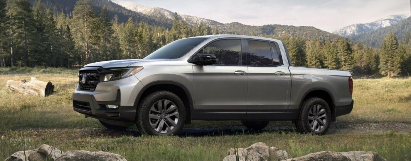 Grey 2025 Honda Ridgeline parked off-road.