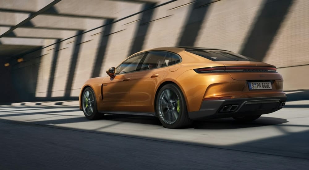 Car Dealer Near Sandy Springs - 2025 Porsche Panamera Turbo S E-Hybrid - Shadows 2.jpg An orange 2025 Porsche Panamera Turbo S E-Hybrid is shown from the side.