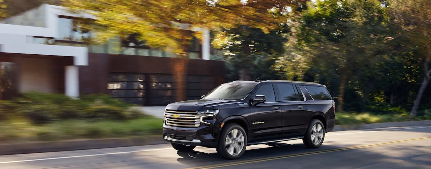 A black 2022 Chevy Suburban is shown from the front at an angle after leaving an SUV dealership.