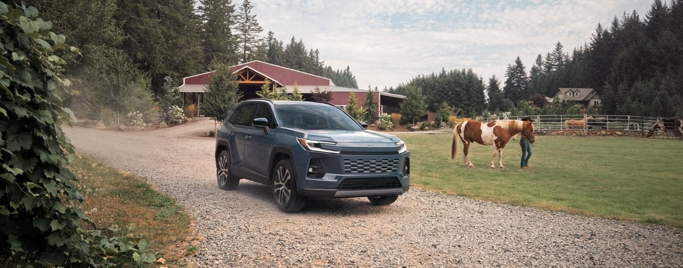 Grey 2026 Toyota RAV4 Limited parked near a barn