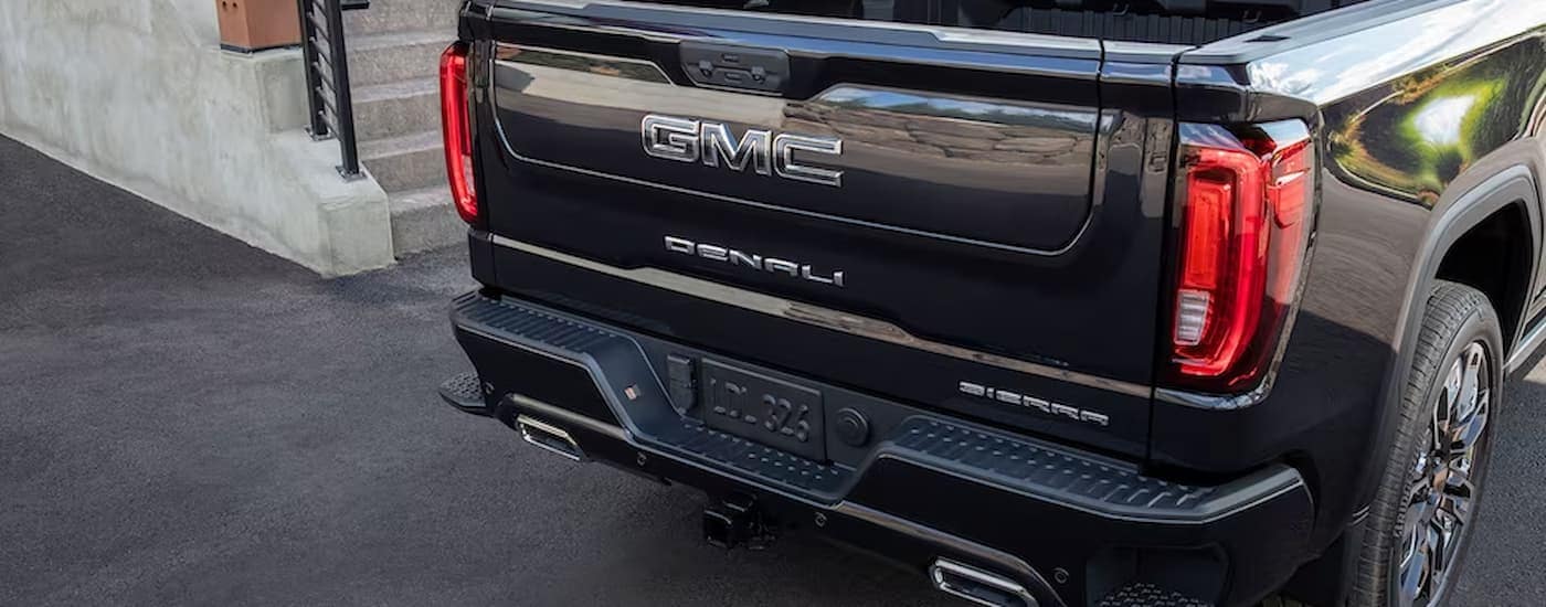 A close up of the rear of a black 2024 GMC Sierra 1500 Denali.