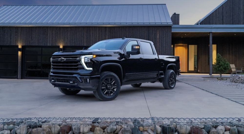 A black Chevy Silverado 2500 HD High Country Midnight Edition parked in a driveway