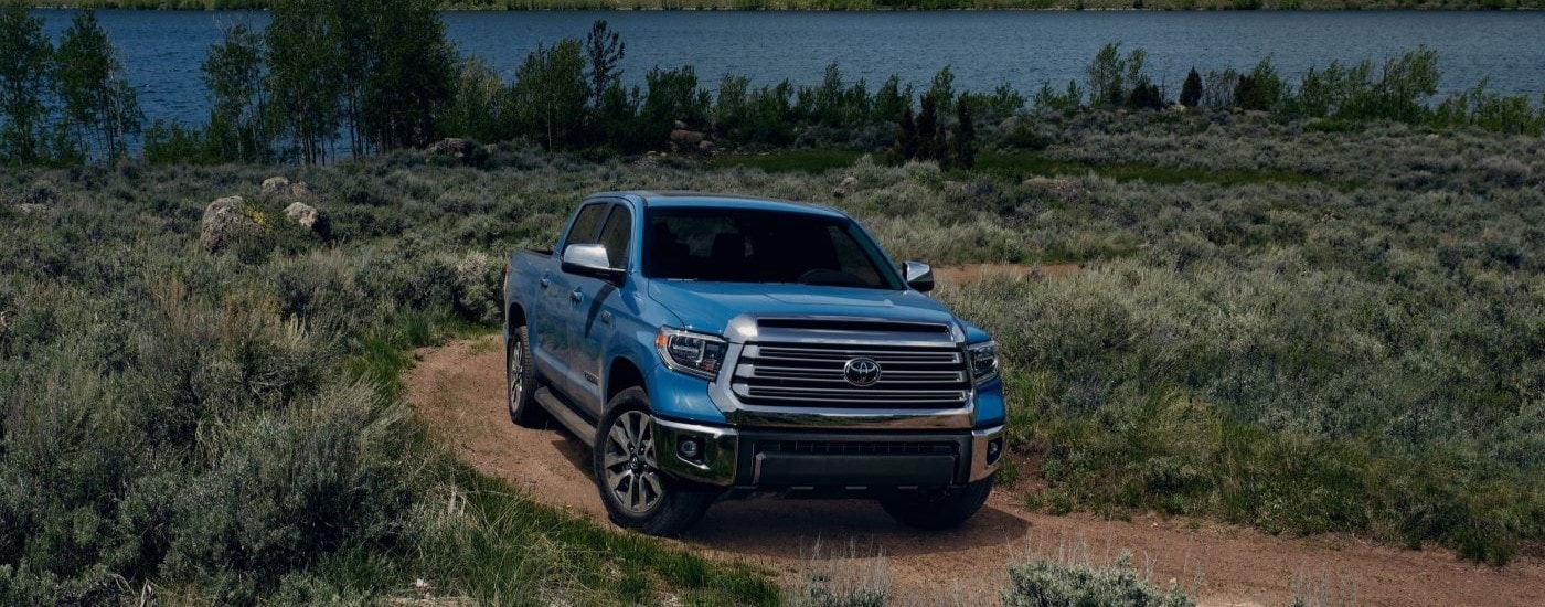 A blue 2020 Toyota Tundra off-roading on a dirt road.