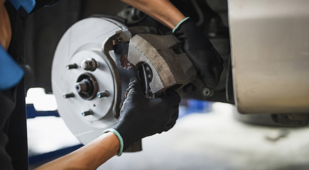 Brake%20Service%20in%20Charlotte%20-%20Caliper%202.jpg A mechanic is shown holding a caliper during a brake service in Charlotte.