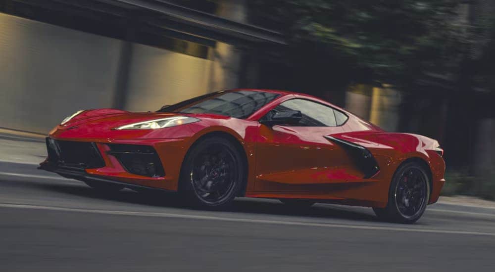 A red 2026 Chevy Corvette Stingray driving down a street