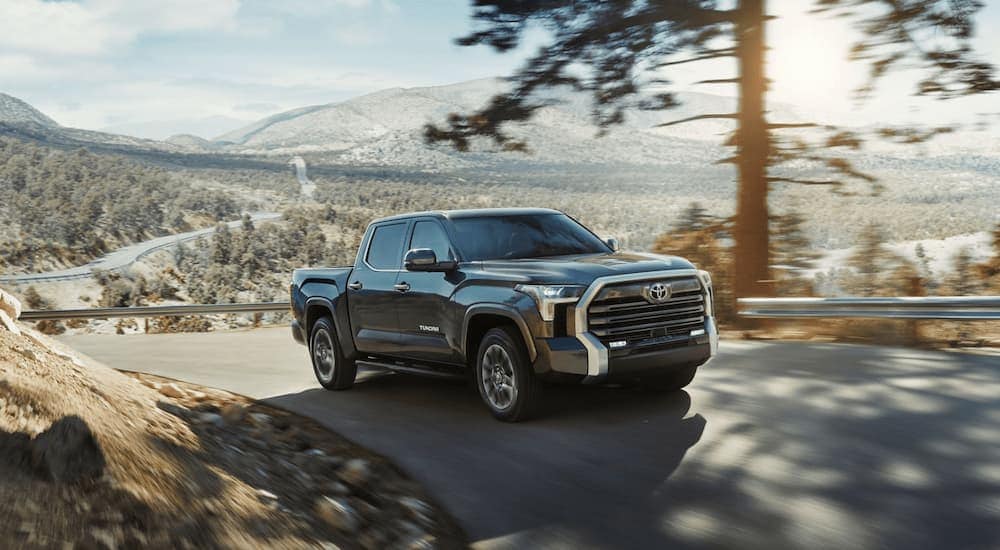 A grey 2024 Toyota Tundra is driving up a hill.