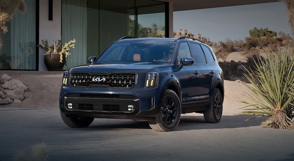 Raleigh%20Cars%20for%20Sale%20-%202024%20Kia%20Telluride%20-%20-%20House.jpg Left angled view of a black 2024 Kia Telluride parked outside a house.