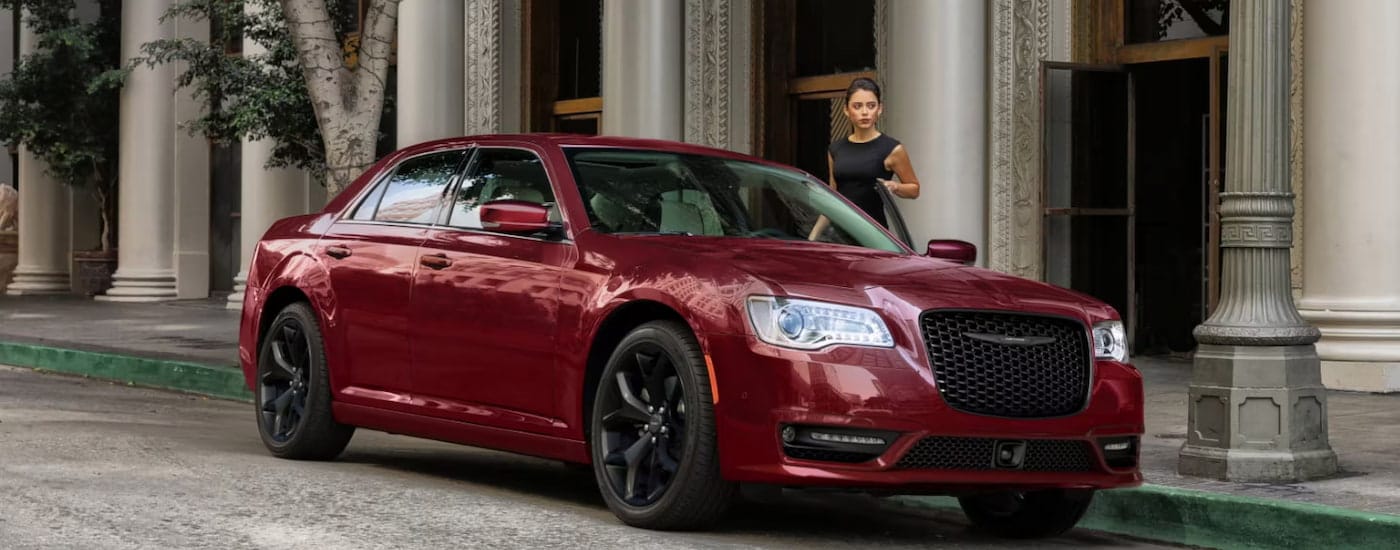 A red 2023 Chrysler 300 Touring L parked on a city street.