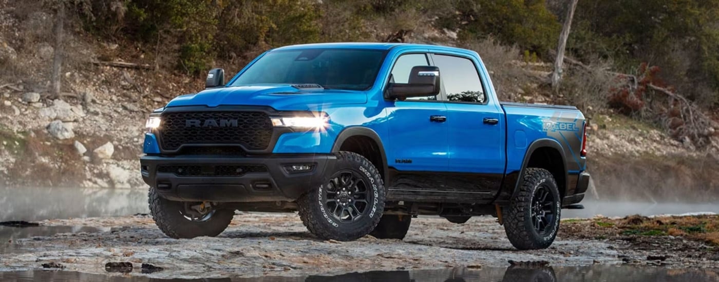 A blue 2024 Ram 2500 from the front at an angle after leaving a dealer that has trucks for sale near Atlanta.