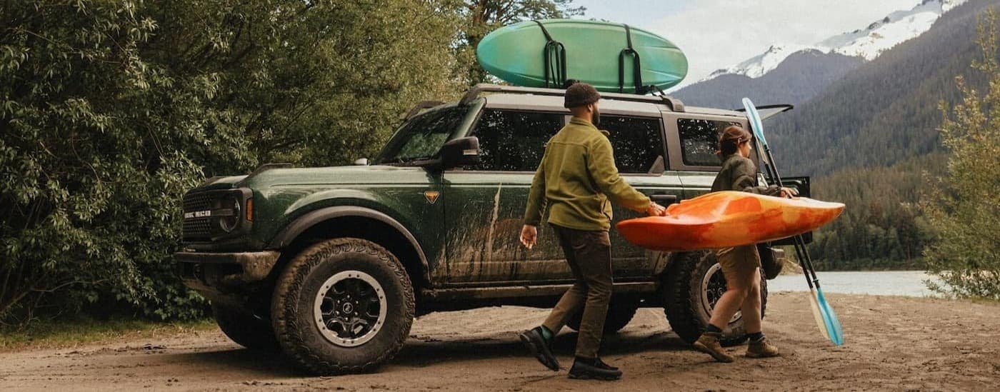 A 2025 Ford Bronco Badlands is shown parked near a lake.