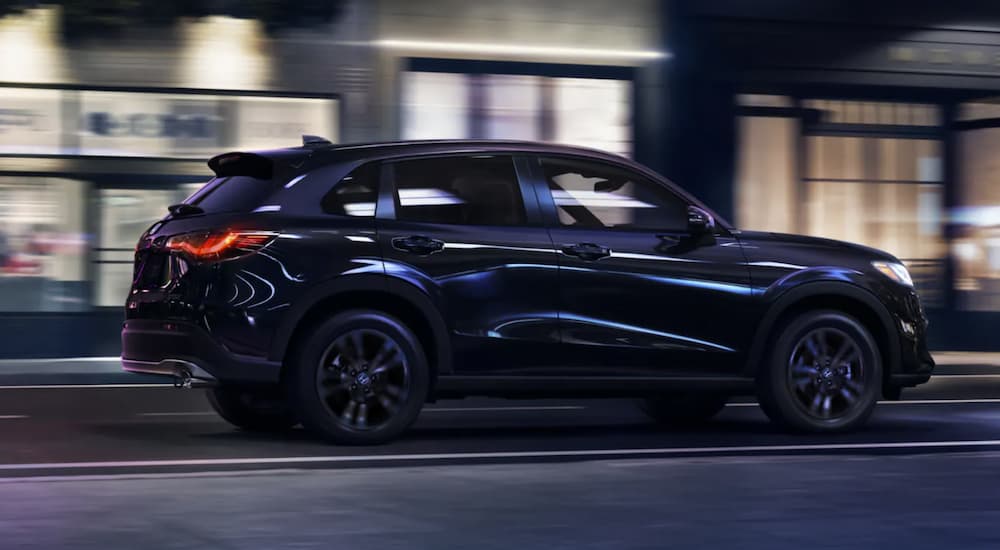 A black 2026 Honda HR-V driving in a city