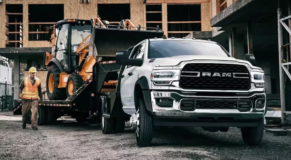 Commercial%20Truck%20Dealer%20in%20Charleston%20-%202024%20Ram%205500%20Chassis%20Cab%20-%20Towing.jpg A white 2024 Ram 5500 Chassis Cab is shown towing a trailer to a commercial truck dealer in Charleston.