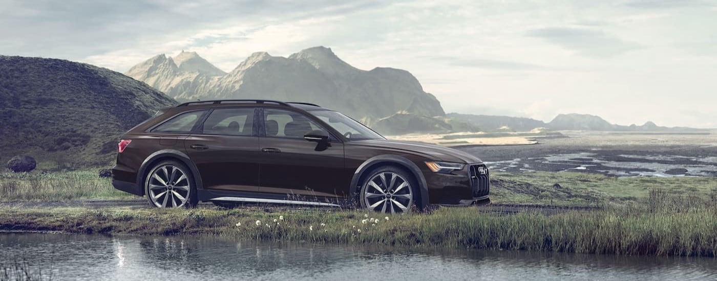 A brown 2025 Audi A6 allroad is shown driving near a marsh.