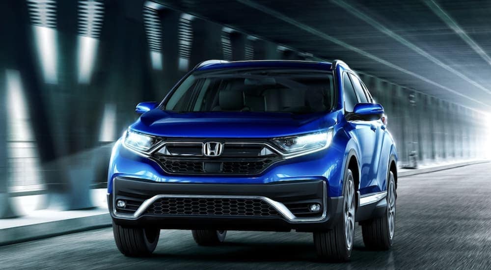 used%20cars%20for%20sale%20near%20Durham%20-%202022%20Honda%20CR-V%20-%20Touring.jpg A blue 2022 Honda CR-V driviing in a tunnel.
