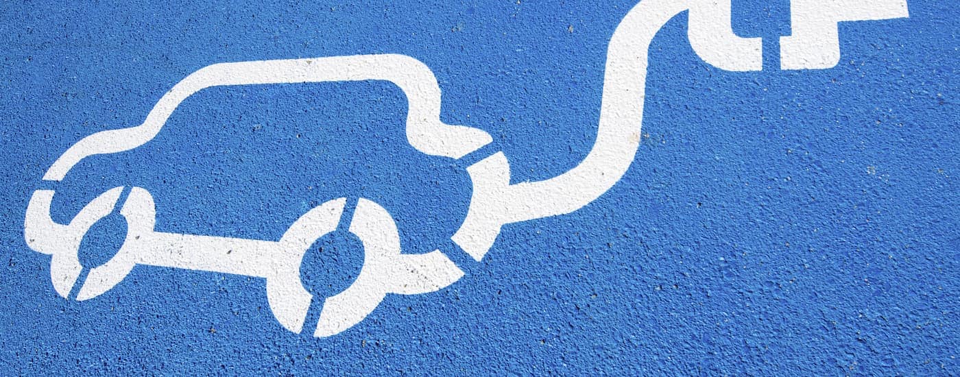 A close up of a blue EV parking spot is shown.