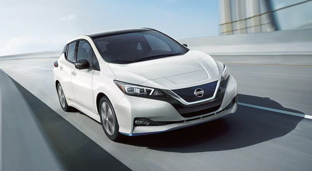 A white 2021 Nissan LEAF is shown from the front at an angle