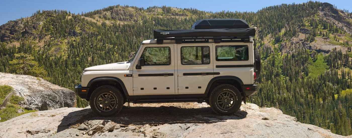 White 2026 INEOS Grenadier Wagon parked on a mountain top trail