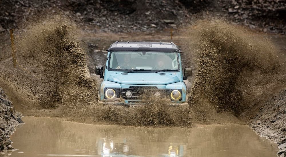 A blue 2025 INEOS Grenadier Quartermaster for sale off-roading.