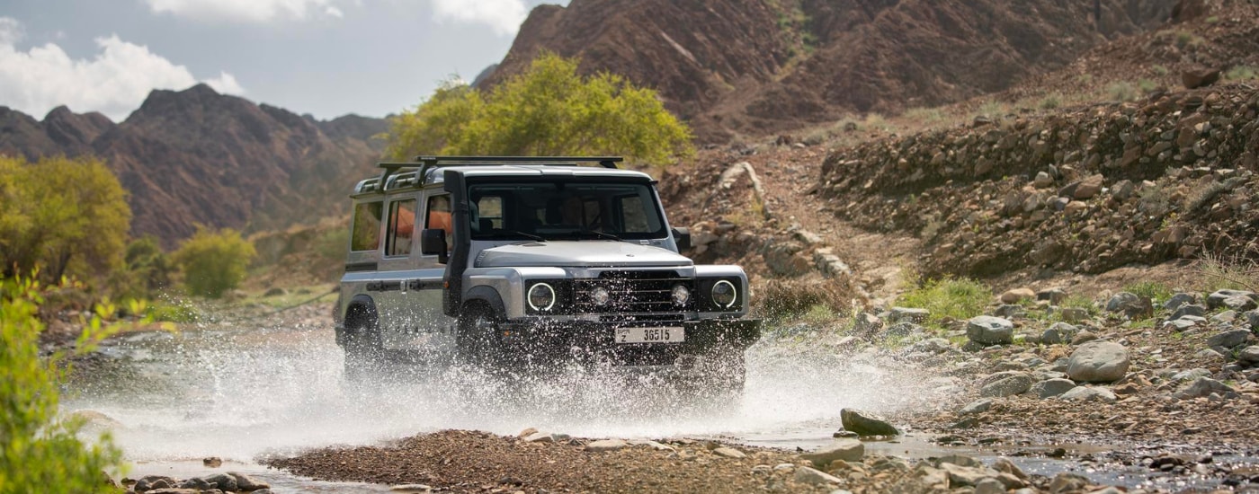 White 2025 INEOS Grenadier Trailmaster driving through water