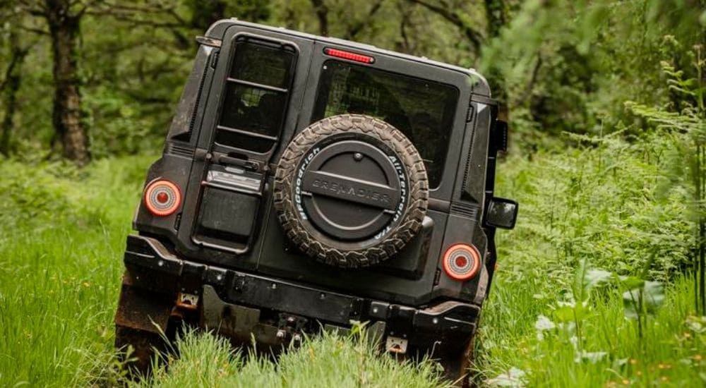 Rear view of a grey INEOS Grenadier off-roading.