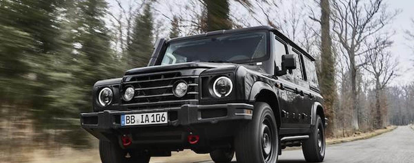 A black 2026 INEOS Grenadier driving down a road