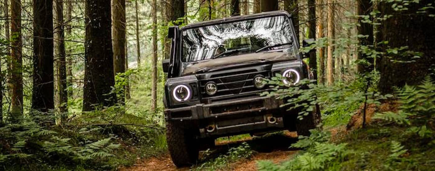 A green 2025 INEOS Grenadier Station Wagon  for sale off-roading.