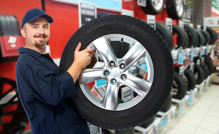 Car mechanic with tire.jpg