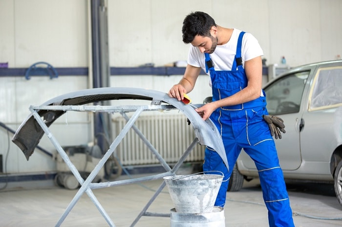 Mechanic_Working_On_Bumper.jpg