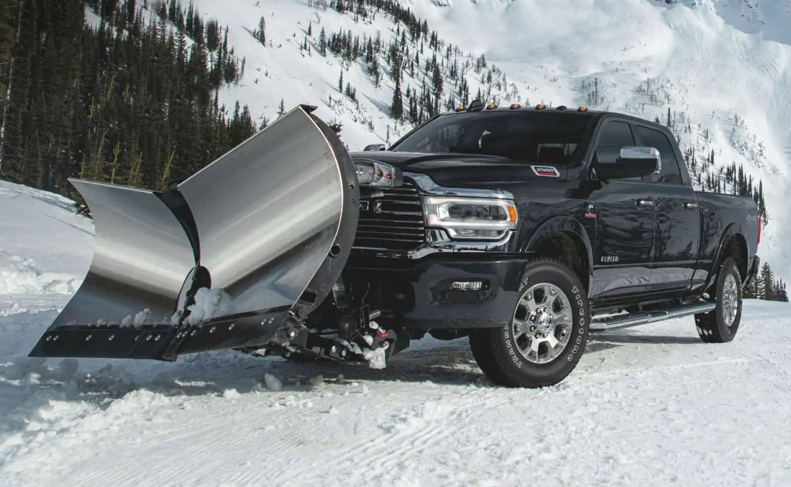 RAM truck with a snowplow attachment on a snowy hill