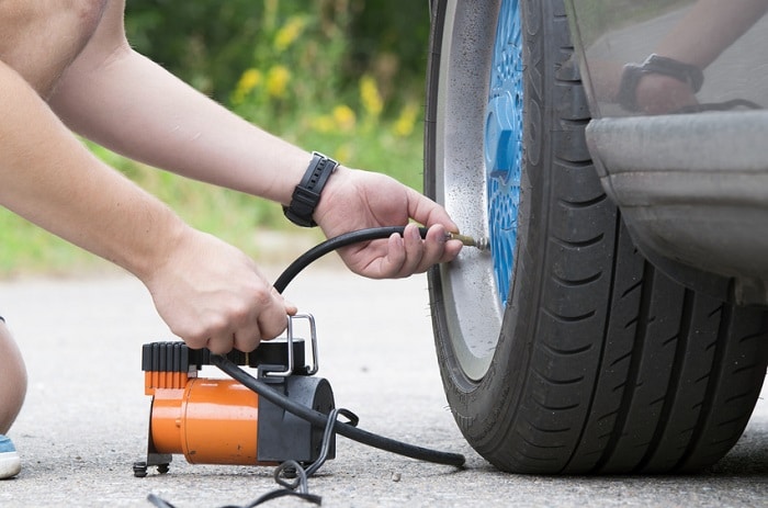 Checking_Car_Tire_Pressure.jpg