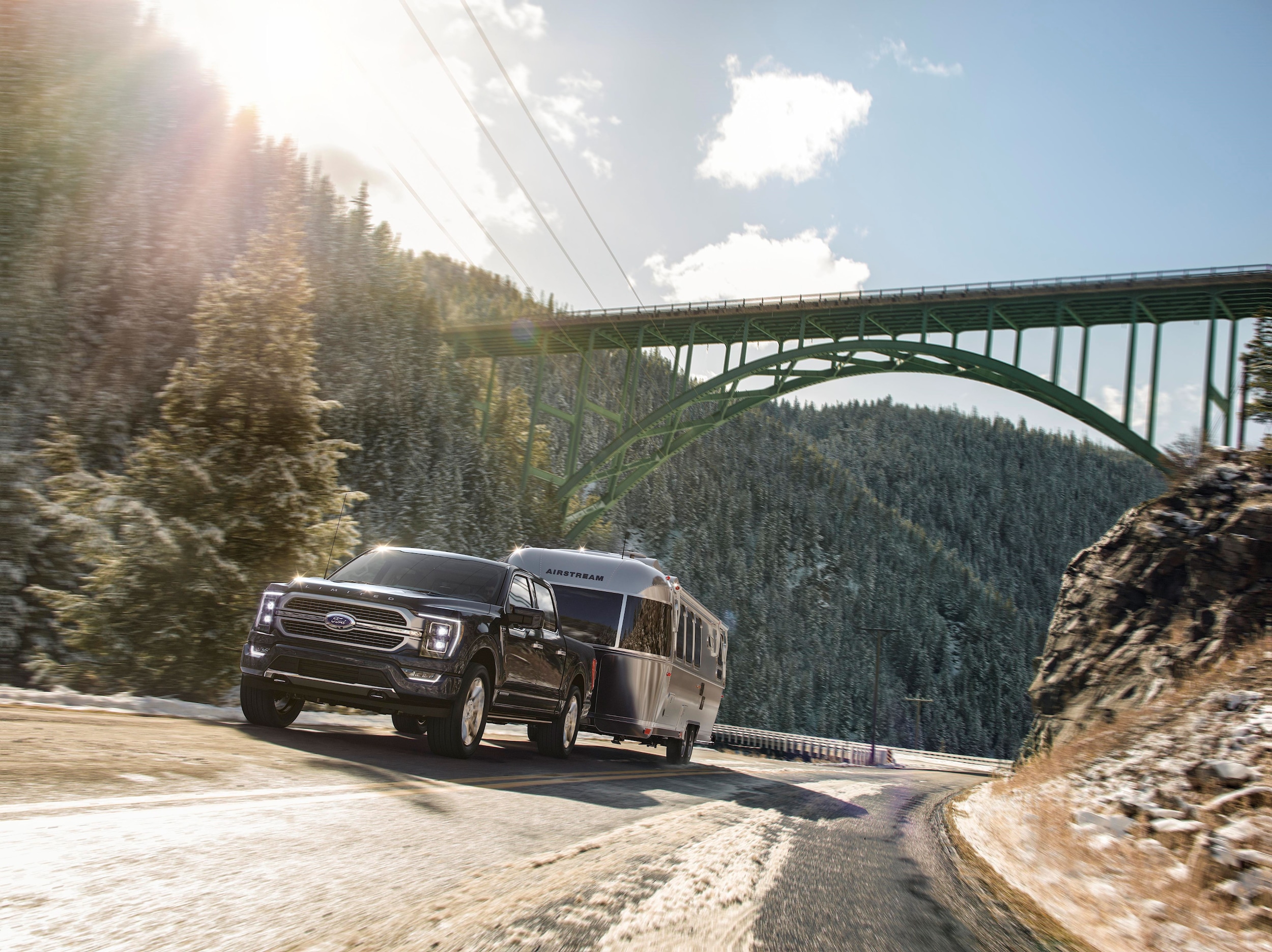 Black Ford F-150 Towing Trailer under Bridge Compressed.jpg