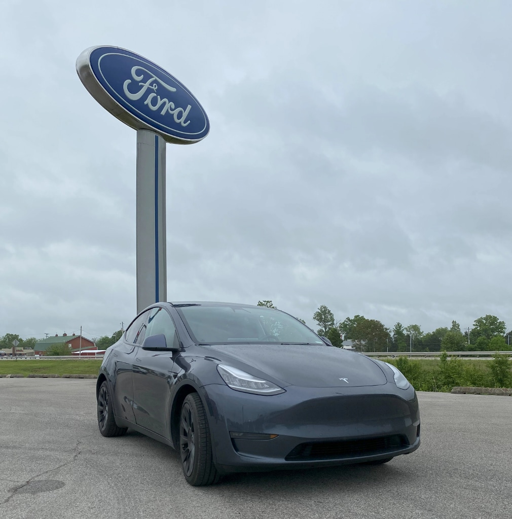 Tesla In front of Ford Sign