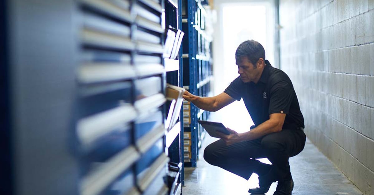 Service technician looking through parts drawers