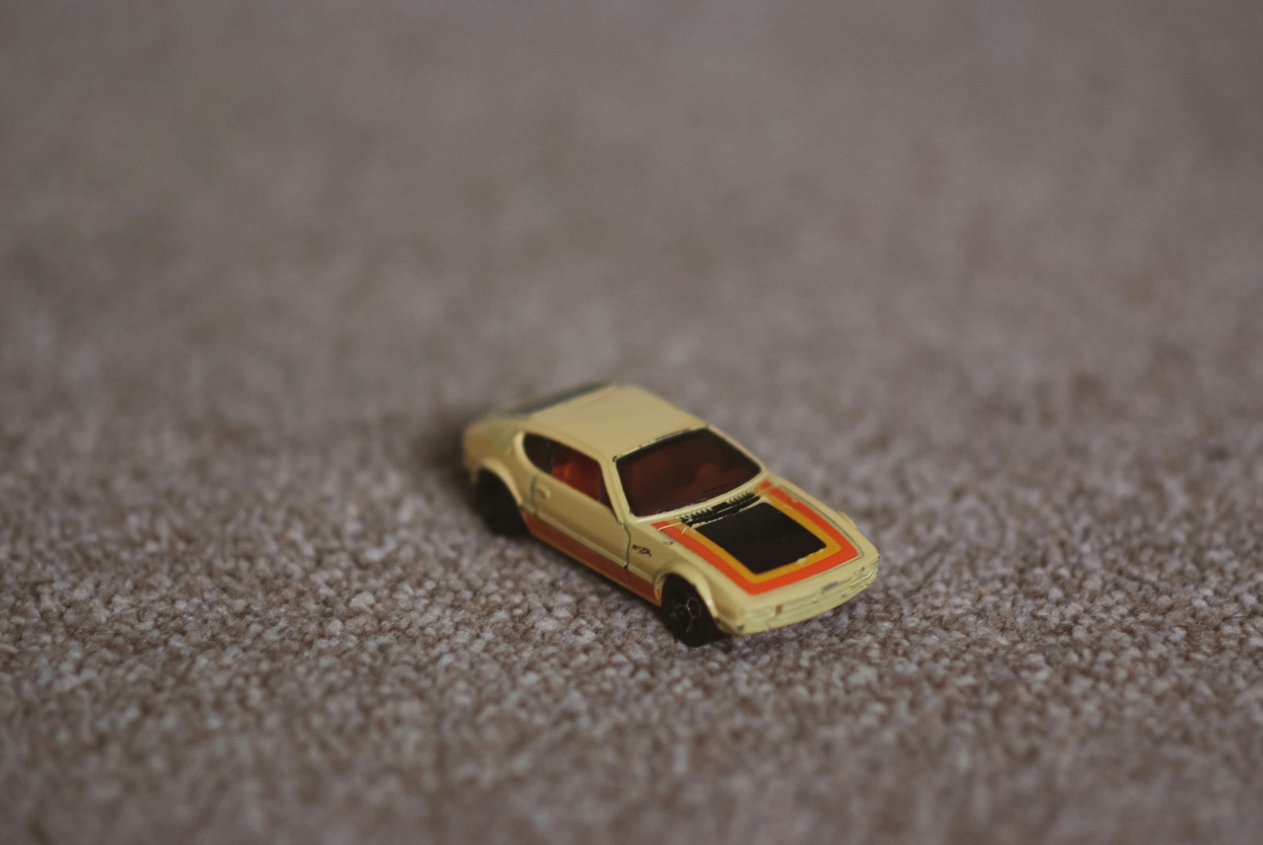 close-up photo of toy car on carpet