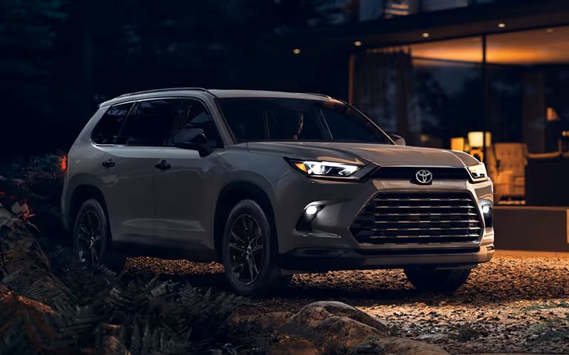 2026 Toyota Grand Highlander parked by house at night