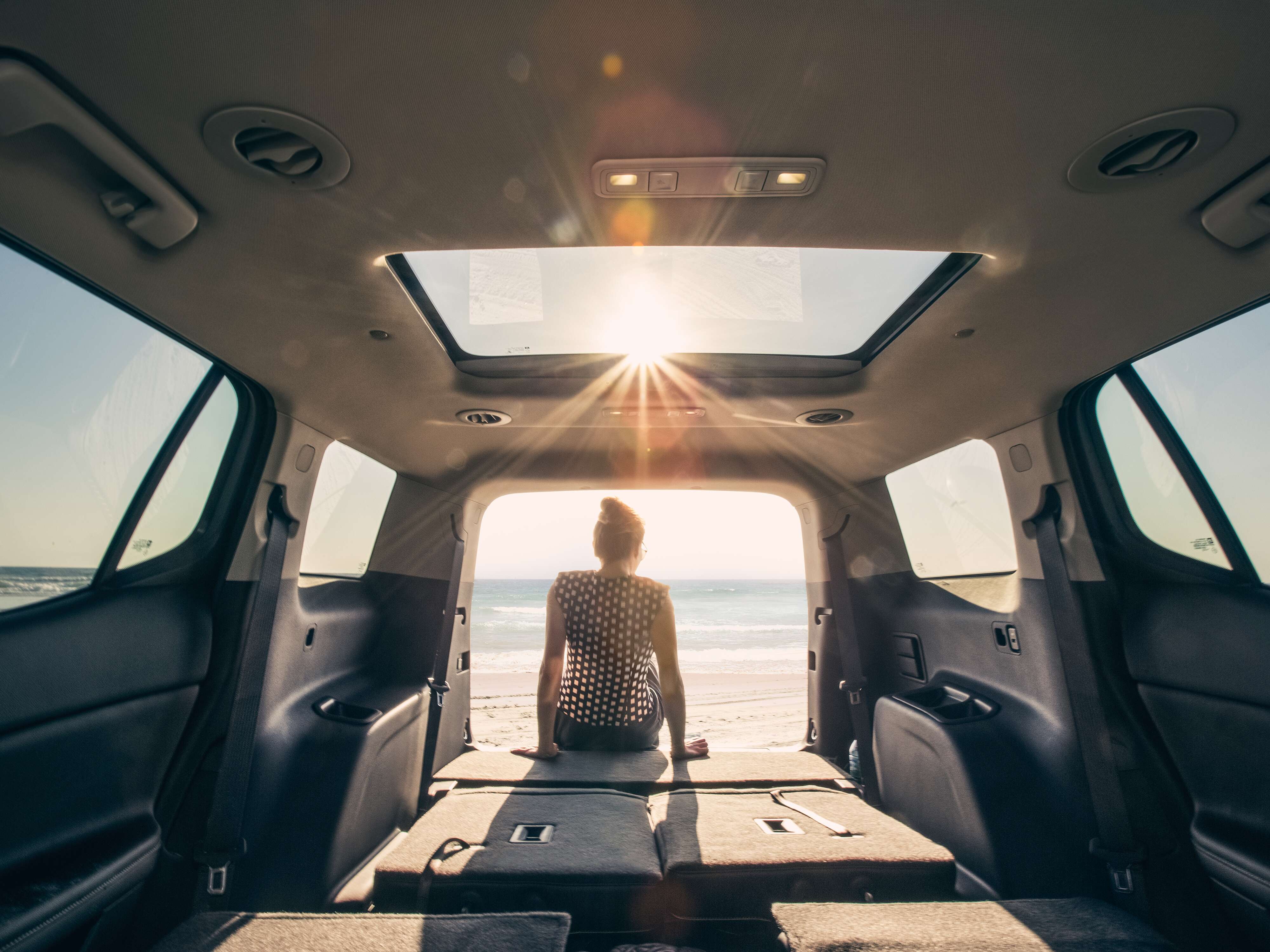 Person sitting in the back of a GMC SUV