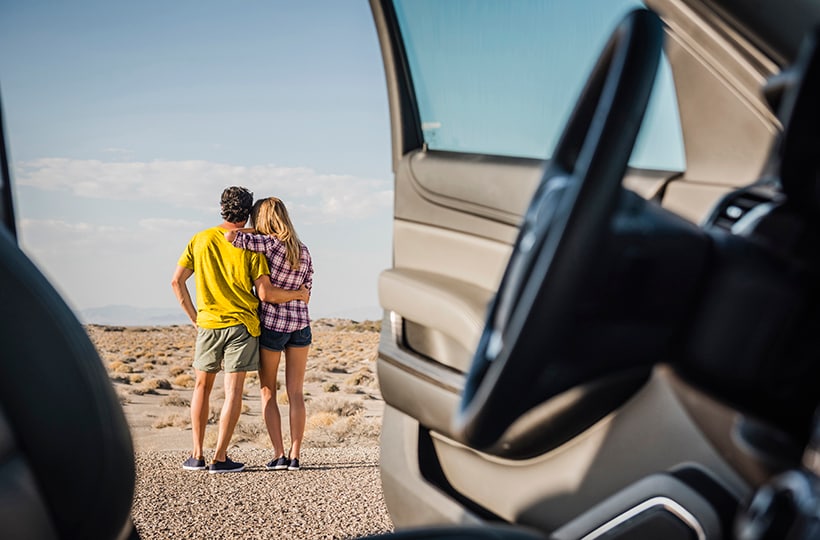  A couple embracing while looking out a desert view