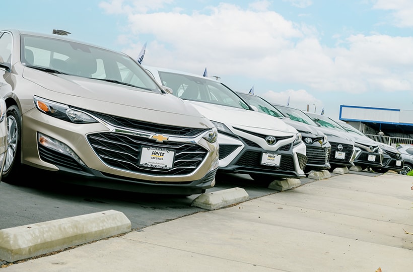 A lineup of vehicles at a Hertz Car Sales location