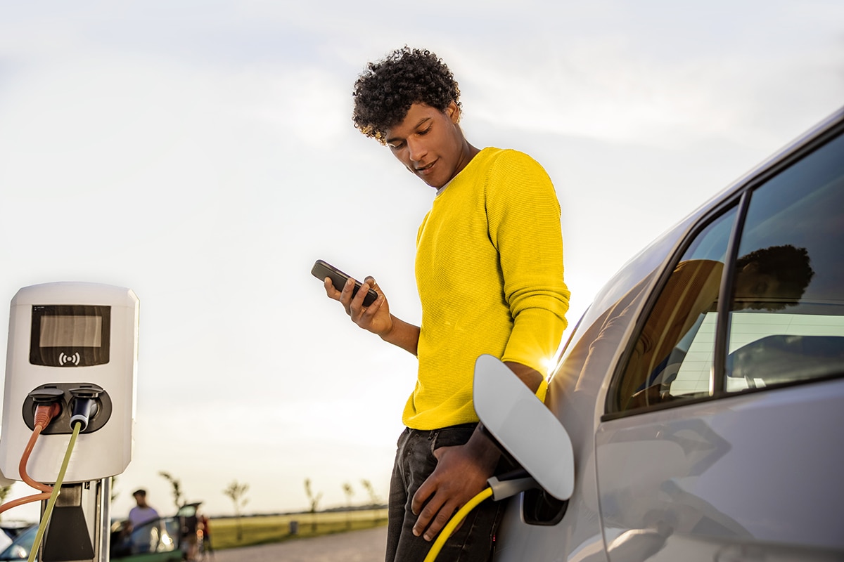  Man using public EV charging station