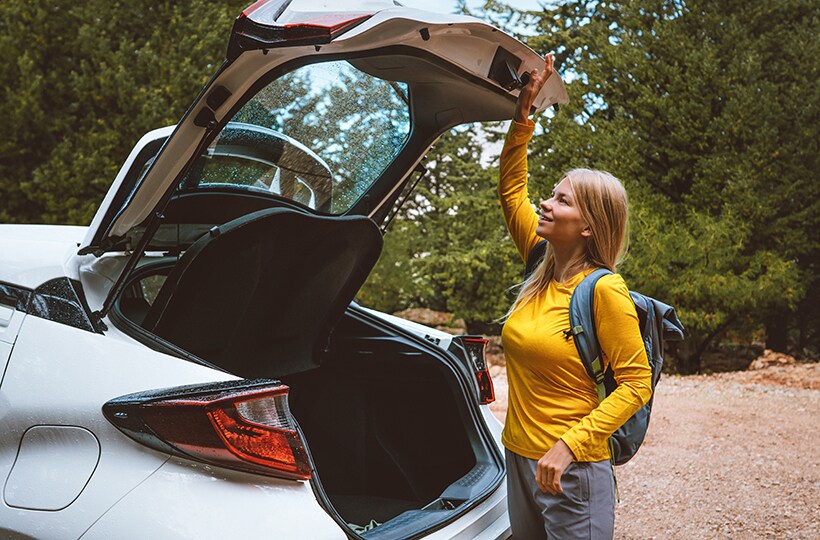 Woman closing the back of a hatchback